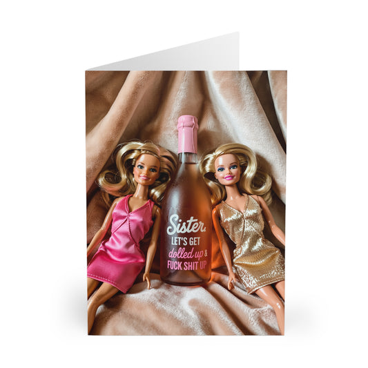 Two dolls with a bottle labeled 'Sister, let's get dilled up' on a white background